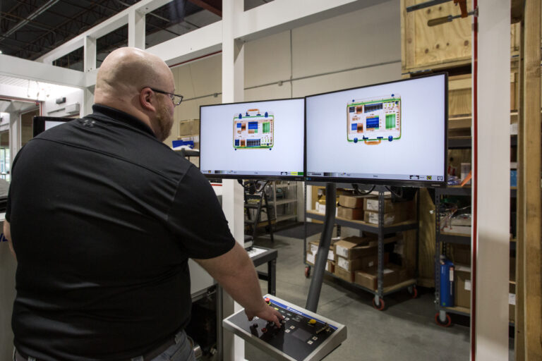 Isotec Employee looking at test object's x-ray results